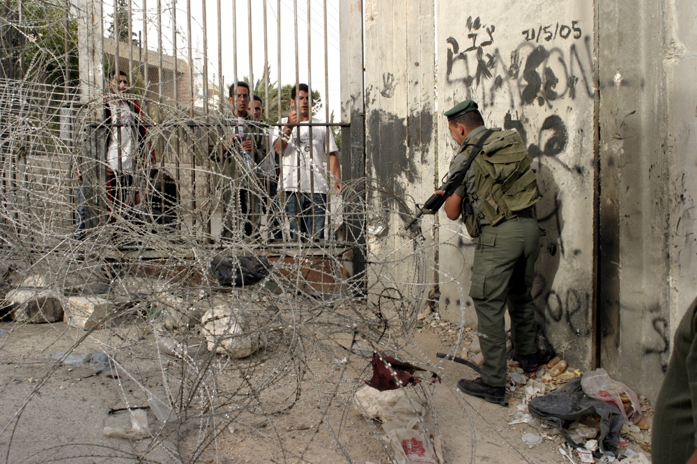 Soldier closing fence, Abu Dis June 07 05 03