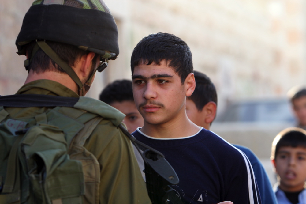 Young Palestinian and soldier, Hebron,  29.11.05  03